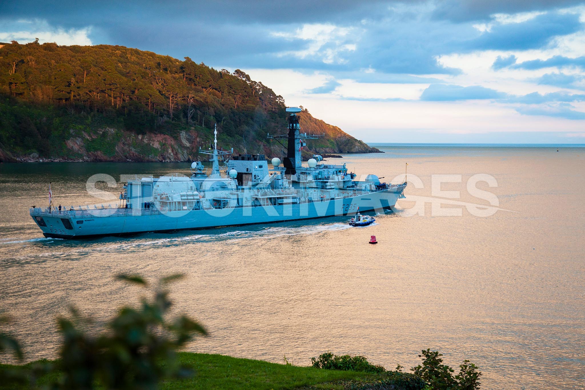 HMS Monmouth passes the Dartmouth Castle as she returns to sea.