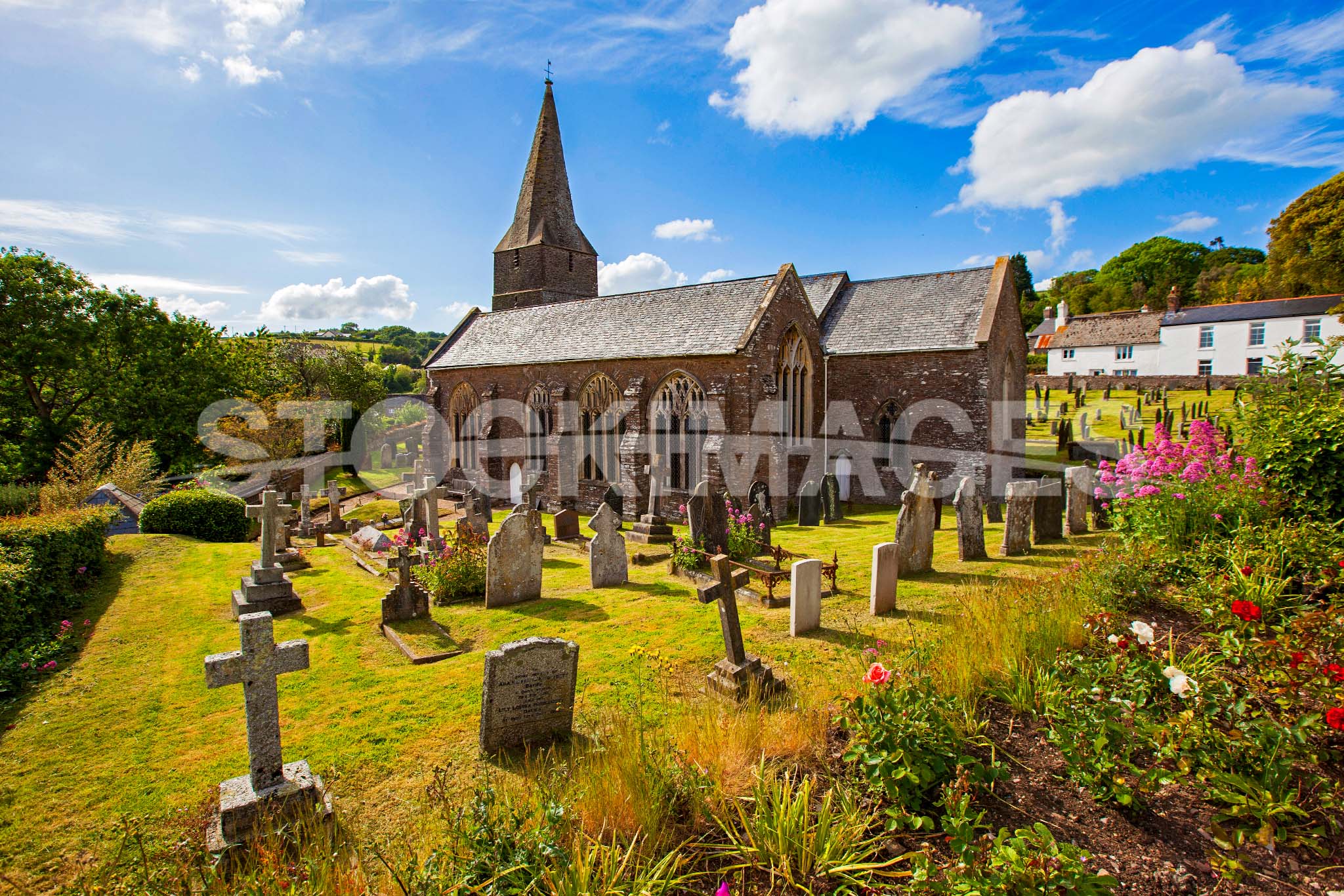Landscape image of St James Church in Slapton in the sunshine.