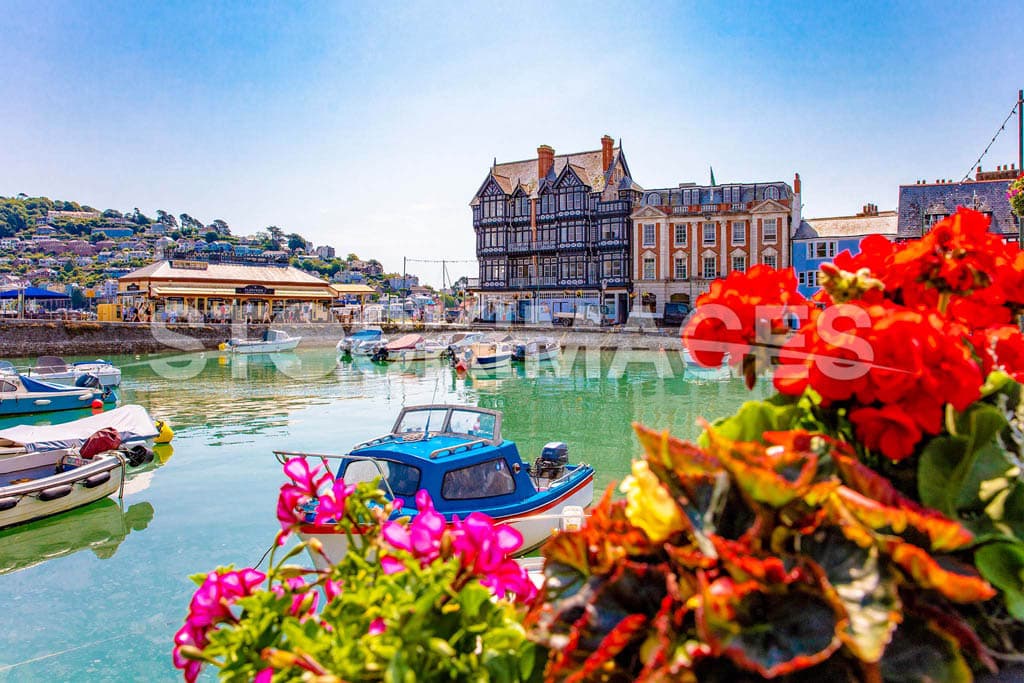 A vibrant and colourful image of the Boat Float in Dartmouth, looking towards Platform 1 and the River Dart on a bright summer's day.