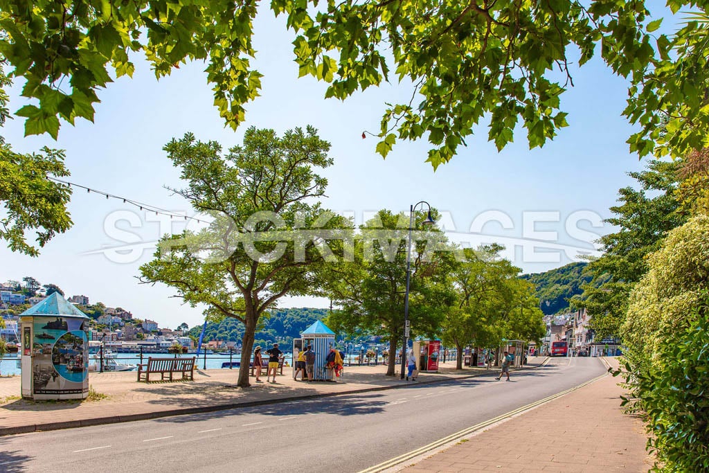 Image of the North Embankment and bus stops alongside the River Dart, outside the Royal Avenue Gardens.
