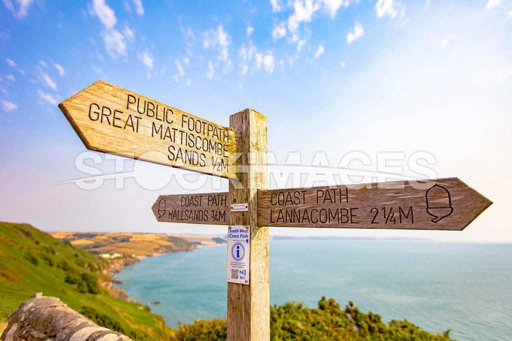Signage for footpath routes on the way down to the Start Point Lighthouse, a popular walk along the South West Coast Path.