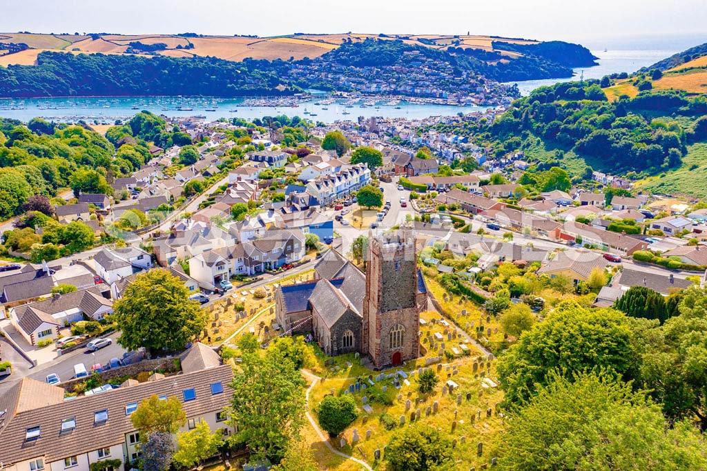 An aerial image of St Clements Church - the 'Mother Church' of Dartmouth, with views over Mount Boone looking down to Dartmouth town and the River Dart.